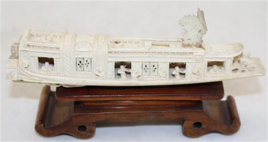 A Chinese ivory model of a boat, early 20th century, 15.5cm, wood stand